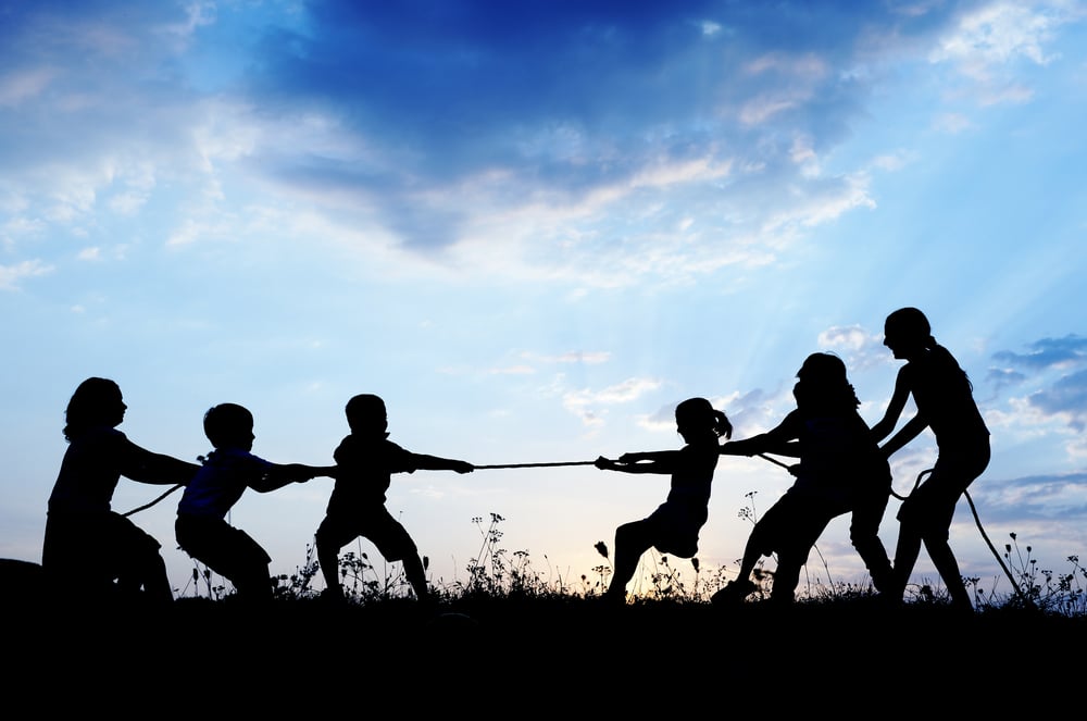 Kids playing tug war pulling rope